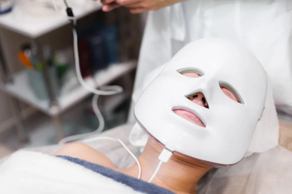 pessoa usando mascará de luz vermelha numa clinica.