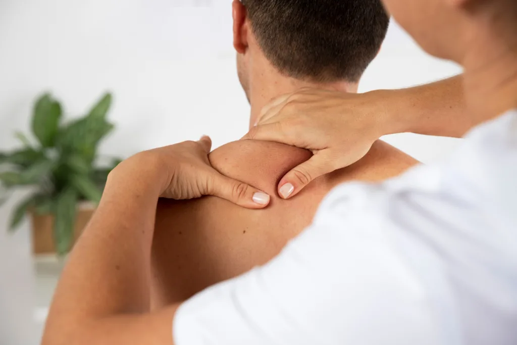 Terapeuta de Shiatsu aplicando pressão em pontos específicos nas costas do paciente, seguindo o trajeto dos meridianos energéticos